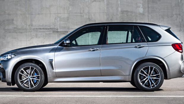A silver Bmw X5 stands parked with a concrete wall background, 4K Desktop Wallpaper