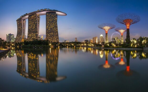 Stunning Singapore skyline at dusk with iconic buildings and reflections in water