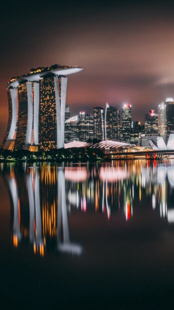 Singapore skyline illuminated at night with reflections on the water in a clear and vivid view