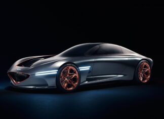 A sleek Genesis car with futuristic lines and copper wheels is showcased in a dark setting, 4K Desktop Wallpaper