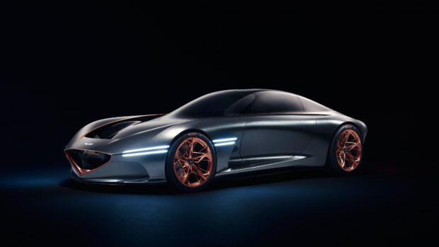 A sleek Genesis car with futuristic lines and copper wheels is showcased in a dark setting, 4K Desktop Wallpaper