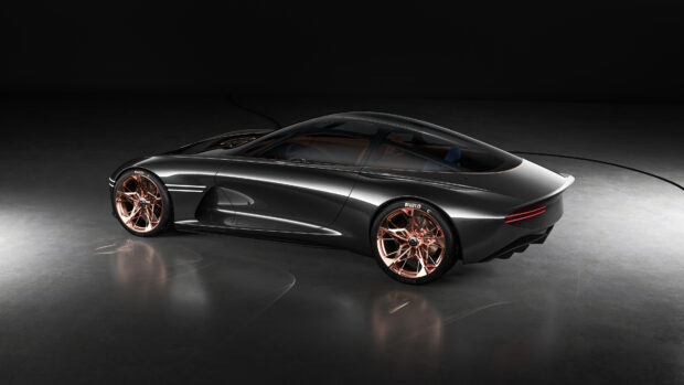 A sleek Genesis car design showcases modern style and copper toned wheels in a dark setting, 4K Desktop Wallpaper