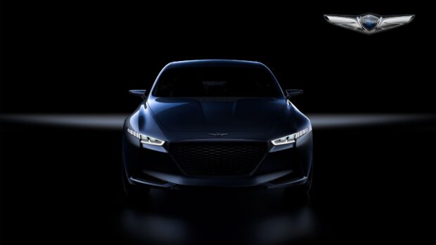 A sleek Genesis car is shown from the front with illuminated headlights in a dark setting, 4K Desktop Wallpaper