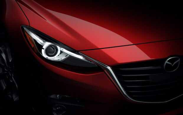 A close up of a sleek red Mazda front with sharp headlights and grille details, HD Desktop Wallpaper