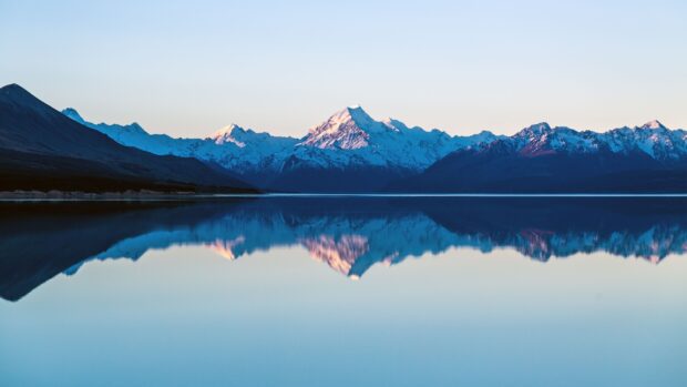 Snowy mountain scenery is reflected in the calm lake under a clear sky, 4K Desktop Wallpaper
