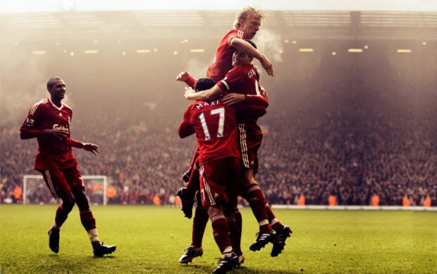 Soccer players celebrating a goal on the field during a competitive soccer match