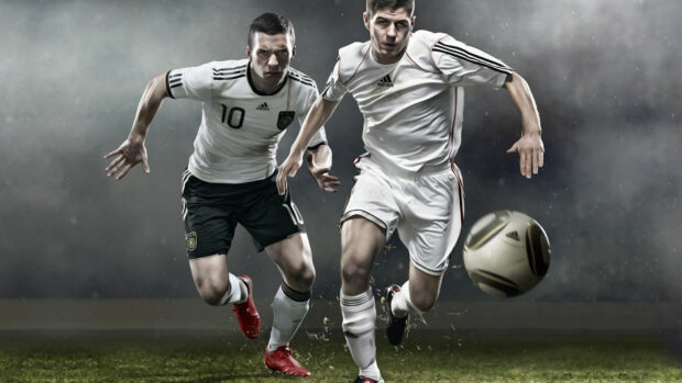 Two soccer players in action chasing a soccer ball on the field