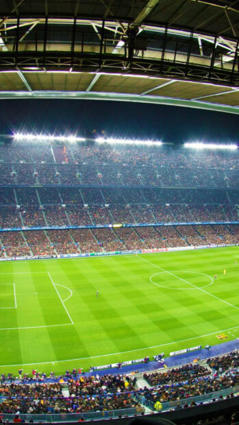 A large soccer stadium filled with fans during a night match at a famous soccer stadium
