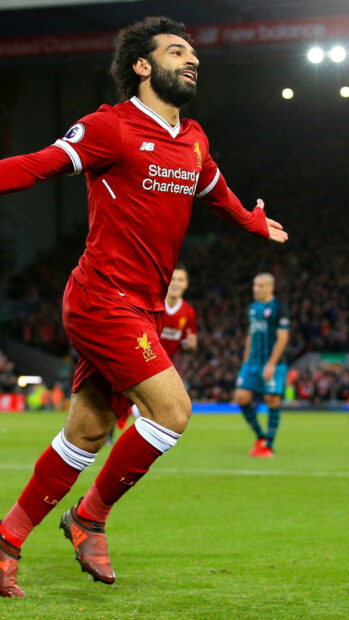 Soccer player celebrating a goal during an intense match on the soccer field