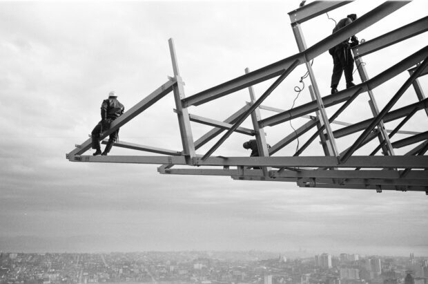 Workers working on steel structure near Space Needle