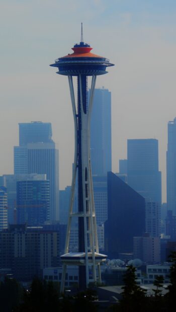 Seattle skyline with the Space Needle tower standing tall among city buildings in foggy weather