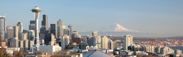 Seattle skyline featuring the Space Needle tower and snowy mountain in the background