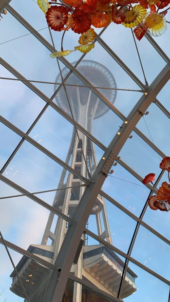 View of Space Needle from inside a glass ceiling with decorative flowers