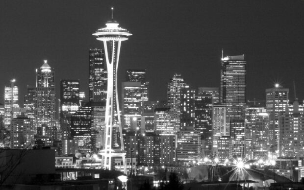 Night view of the Space Needle and city skyline in Seattle with lights illuminated