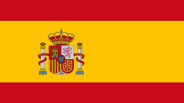 Spain Wallpapers features the red and yellow national flag with the royal coat of arms in the center, 4K Desktop Wallpaper