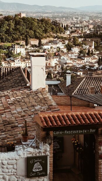 A scenic view of a Spanish town with terracotta rooftops and hills, HD Mobile Wallpaper