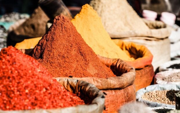 Vibrant piles of colorful spices in market showcasing natural seasoning varieties