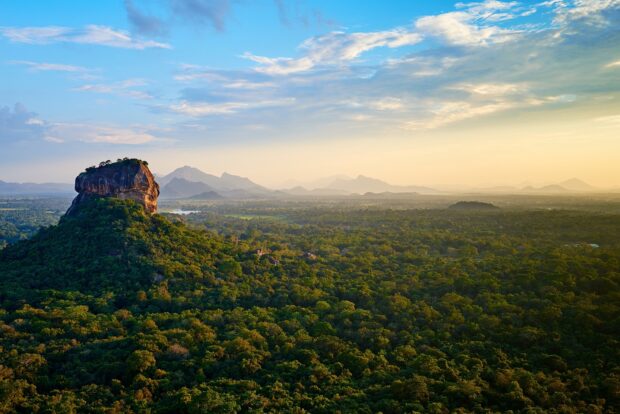 A scenic view of Sri Lanka with a rock formation and lush greenery under a vibrant sky, 2K Desktop Wallpaper
