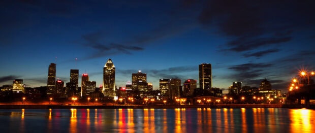 A stunning night view of the St Lawrence River with city skyline lights reflecting on the water