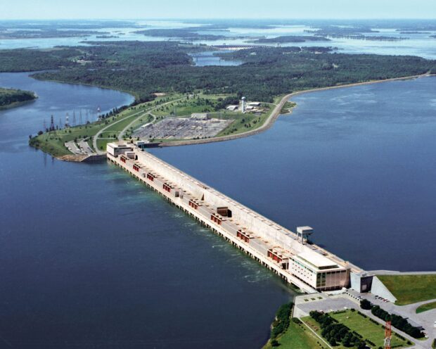 Aerial view of the St Lawrence River dam and surrounding green landscape under clear skies