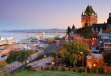 Stunning view of the St Lawrence River with historic buildings and a cruise ship at sunset