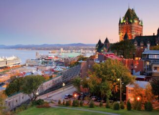 Stunning view of the St Lawrence River with historic buildings and a cruise ship at sunset