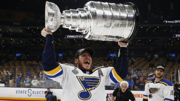 A St Louis Blues player lifts the Stanley Cup trophy in celebration after the final game, 4K Desktop Wallpaper