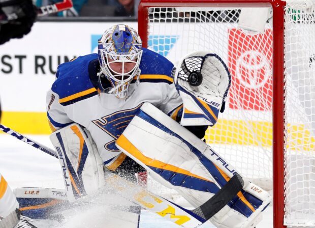A St Louis Blues player is blocking a shot in front of the goal during a hockey game, HD Desktop Wallpaper