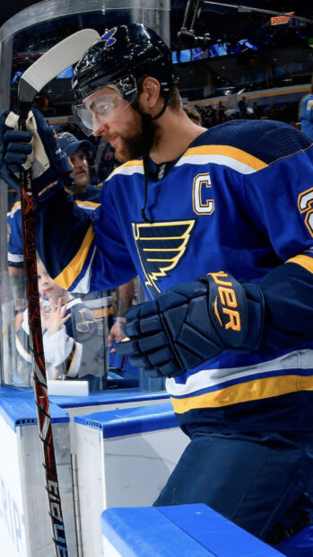 A St Louis Blues player in full gear focuses before a game, HD Phone Wallpaper