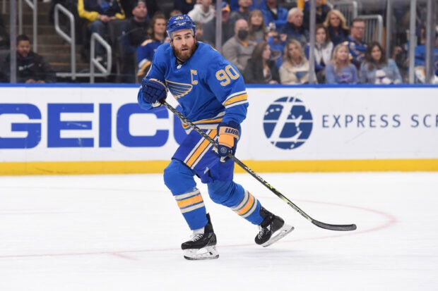 A St Louis Blues player skates on the ice during a game with intense focus, 2K Desktop Wallpaper