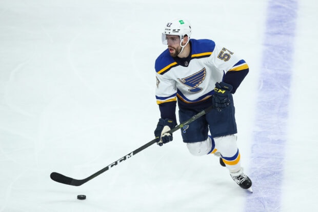 A St Louis Blues player is skating on the ice while controlling the puck during a game, 2K Desktop Wallpaper