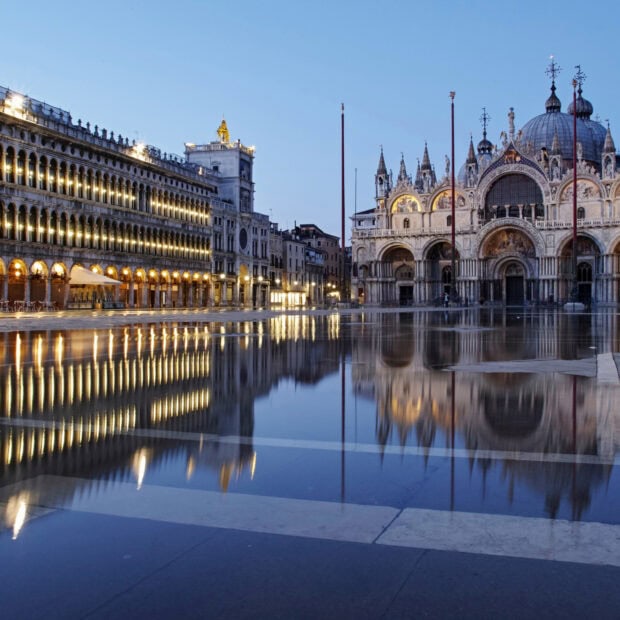 The illuminated St Marks Basilica reflects on the wet square during twilight, HD Desktop Wallpaper