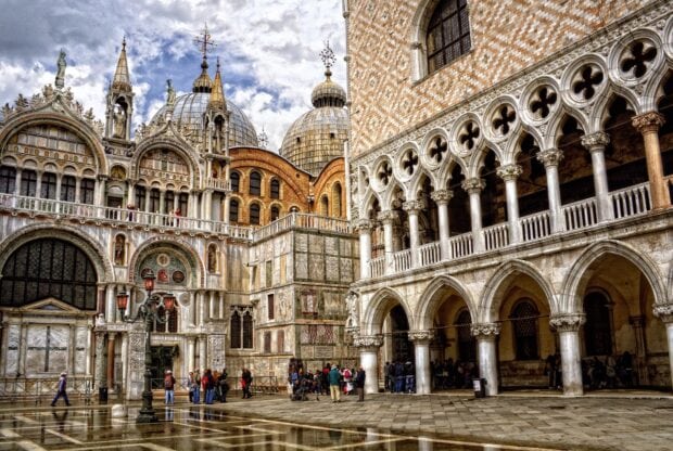 The ancient detailed architecture of St Marks Basilica with tourists standing nearby, HD Desktop Wallpaper