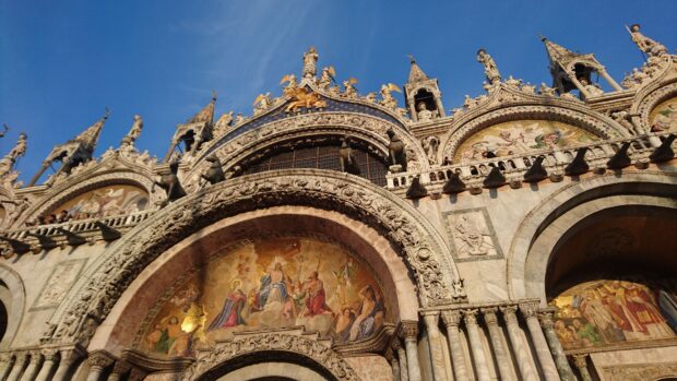 The image shows the detailed facade and mosaics of St Marks Basilica under a clear blue sky, 4K Mobile Wallpaper