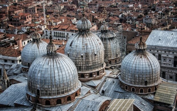An aerial view of the domes of St Marks Basilica surrounded by historic buildings, 2K Desktop Wallpaper