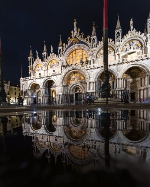 The illuminated St Marks Basilica reflects beautifully in the water at night, 2K Mobile Wallpaper