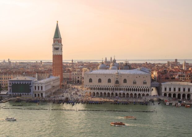 The beautiful view of St Marks Square shows historic buildings and boats on the water, HD Desktop Wallpaper