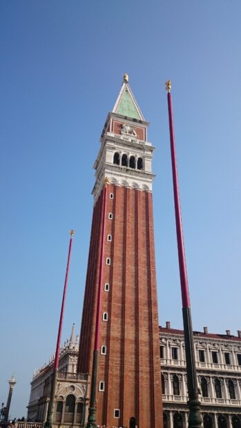 The St Marks Square bell tower stands tall under a clear blue sky, 4K Mobile Wallpaper