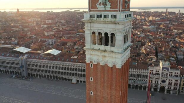 The St Marks Square displays a tall bell tower with surrounding historic buildings at sunset, HD Desktop Wallpaper