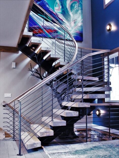 Modern staircase with wooden steps and metal railing in a stylish home interior
