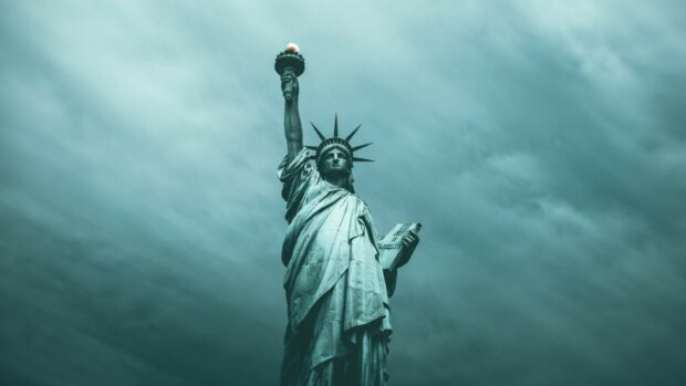 The Statue of Liberty stands tall under a moody cloudy sky, HD Desktop Wallpaper