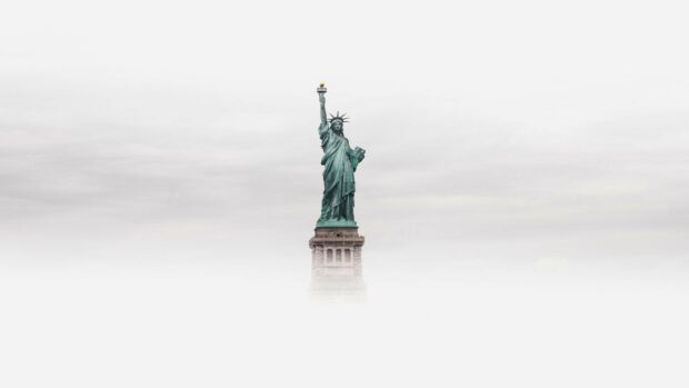 The Statue of Liberty stands tall surrounded by fog and cloudy sky, HD Desktop Wallpaper