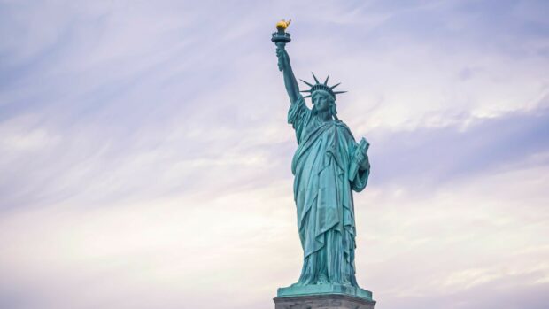 The Statue of Liberty stands prominently against a soft cloudy sky in this image, HD Desktop Wallpaper