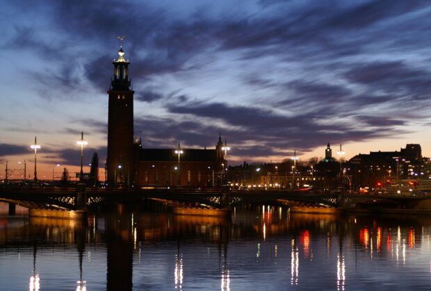 Stockholm cityscape with tower and bridge reflection at dusk in Stockholm