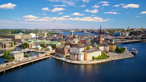 Aerial view of Stockholm city with historic buildings and clear blue water under a bright sky