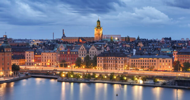Evening cityscape of Stockholm with illuminated historic buildings along the waterfront