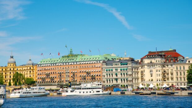 Historic buildings with flags along the waterfront in Stockholm