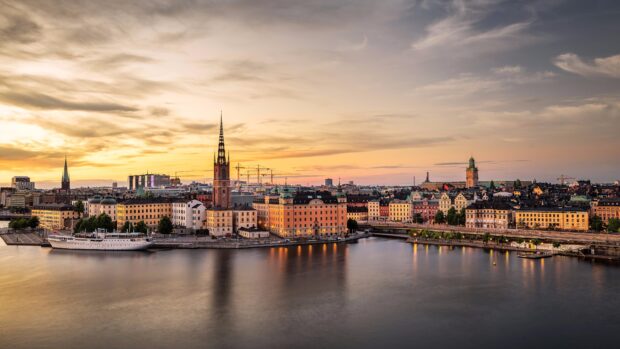 Sunset over Stockholm cityscape with historic buildings and calm water in Stockholm
