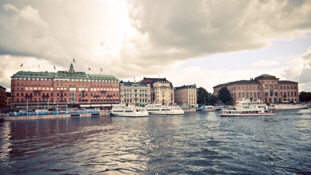 The Stockholm waterfront with historic buildings and boats on a cloudy day