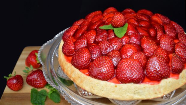 A close up of a strawberry pie topped with fresh berries and a mint leaf, 4K Desktop Wallpaper